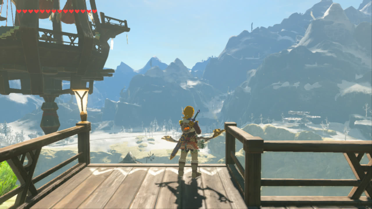 The player character looking contemplatively at snow-capped mountains from a wooden platform