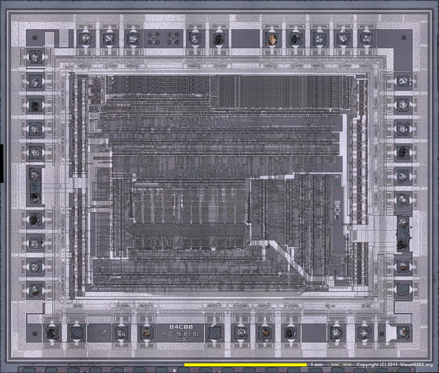 A photo of the die of a CMOS Z80. Large rectangular features surround
                a central rectangle of extremely fine detail.
